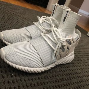 Adidas tubular shoes.